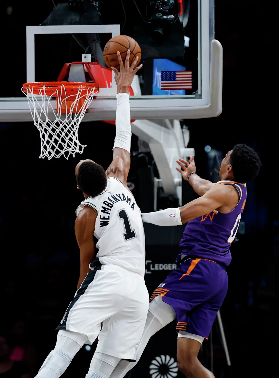 San Antonio Spurs center Victor Wembanyama (1) attempts to block a shot by Phoenix Suns forward Ryan Dunn (0) during the first half of a preseason NBA game at Frost Bank Center in San Antonio, Wednesday, Oct. 14, 2026.