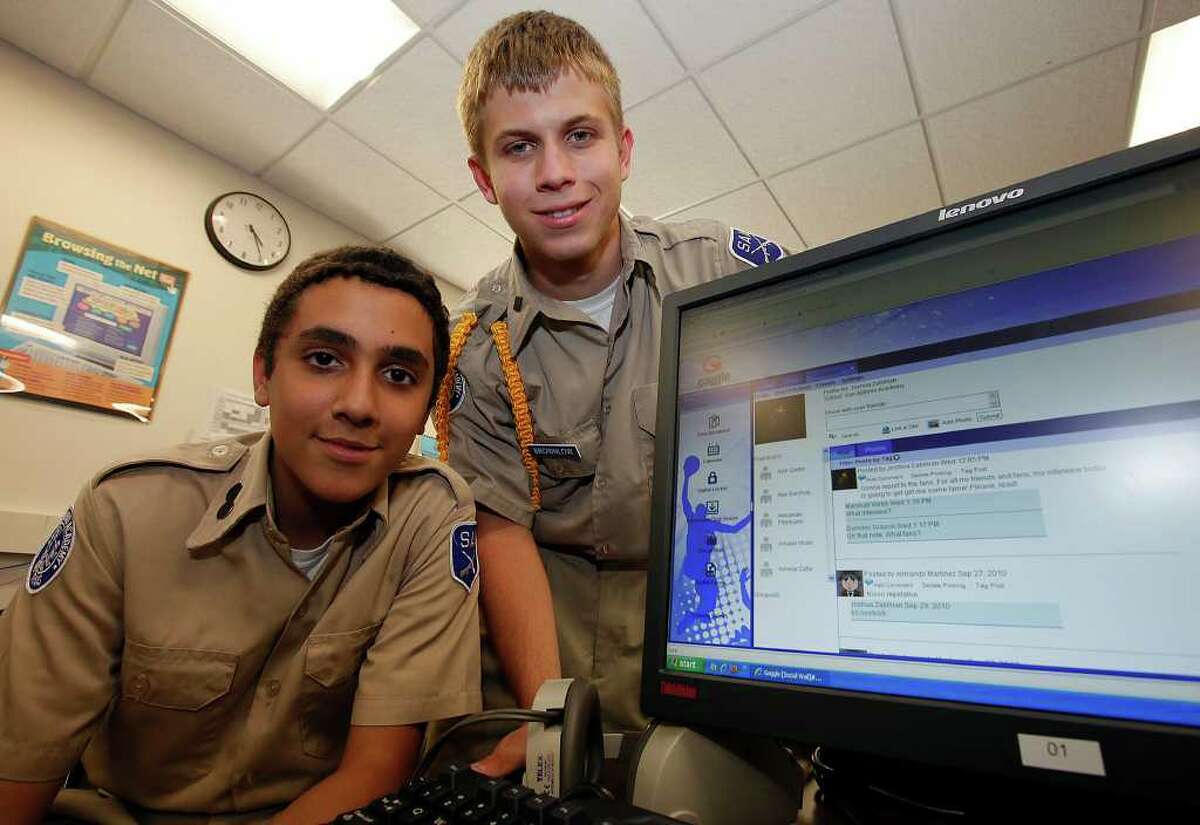 San Antonio Academy eighth-graders Joshua Zabihian (left) and Dustin Brownlow are two of about 200 boys there who use an in-house Internet application by Gaggle called the Social Learning Wall. The application is limited to students at the academy. School officials say it teaches students how to interact within a social network that is safer.