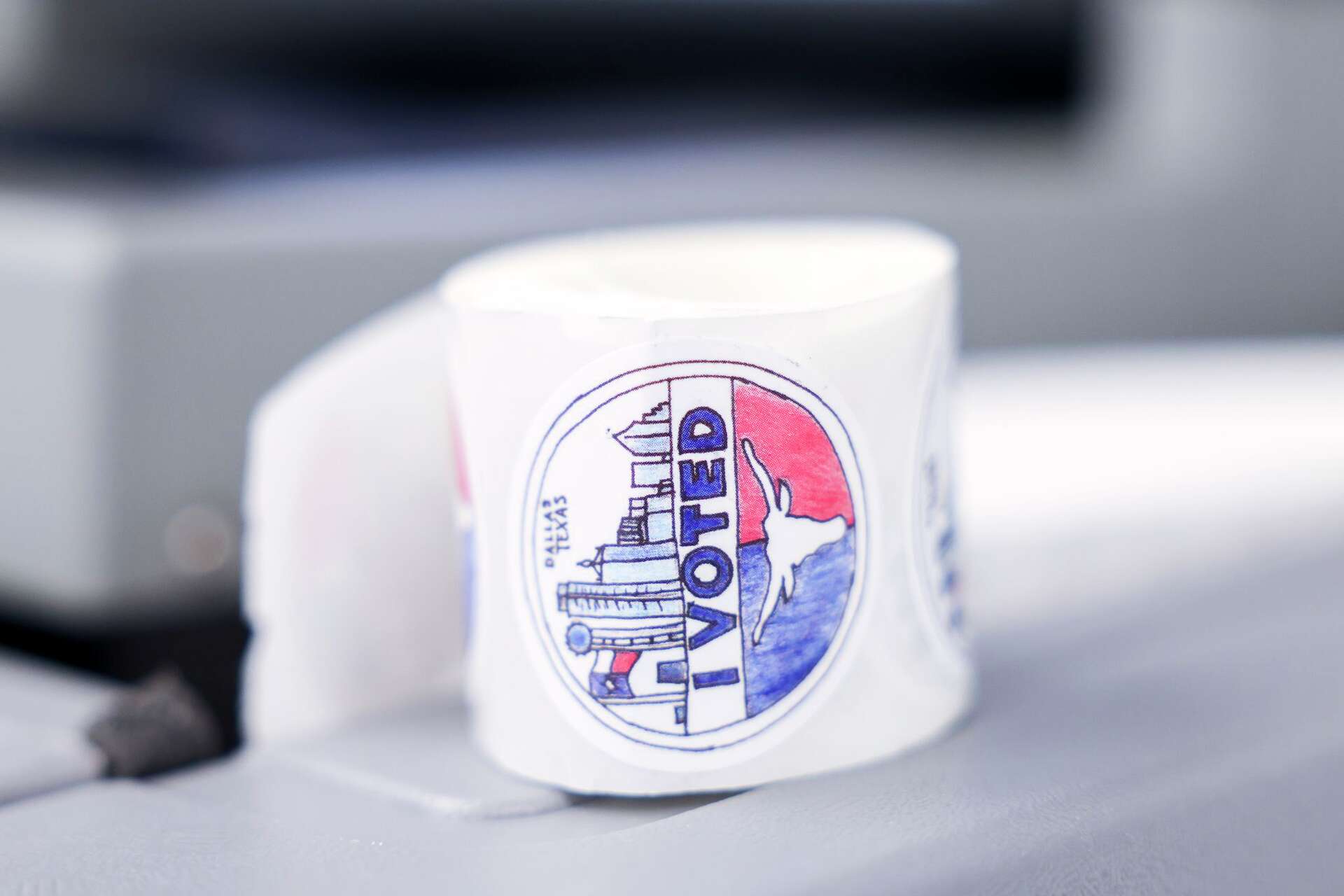 I voted sticker remains by a a polling machine at Dallas County Elections Department, Friday, Oct. 16, 2026, in Dallas.