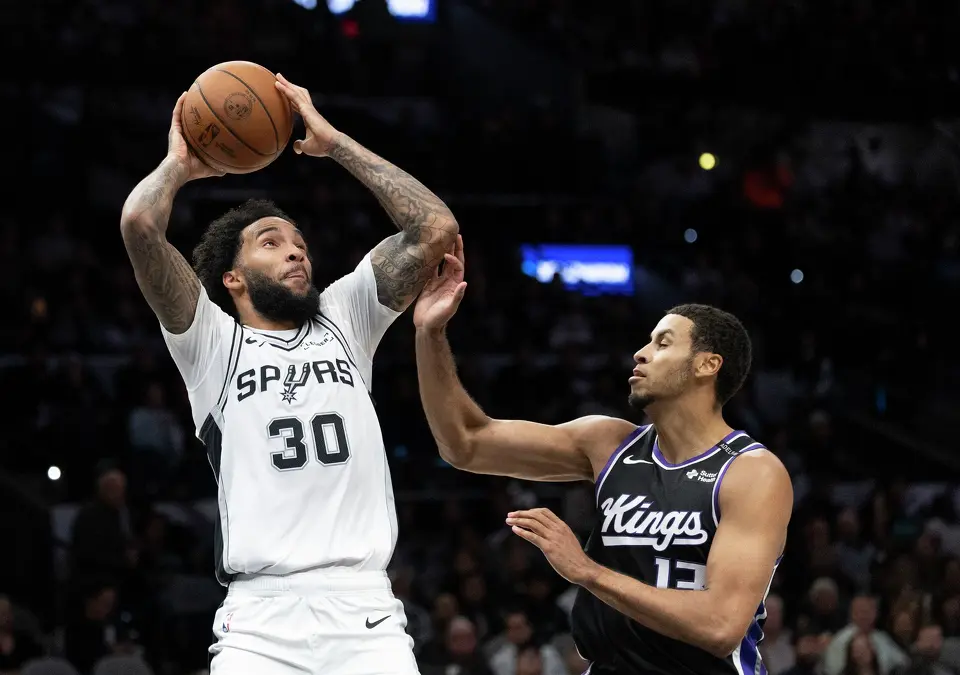 Spurs forward Julian Champagnie (30) looks to shoot while guarded by Kings forward Keegan Murray (13) during the preseason NBA game against the Sacramento Kings at Frost Bank Center in San Antonio, Wednesday, Oct. 16, 2026.