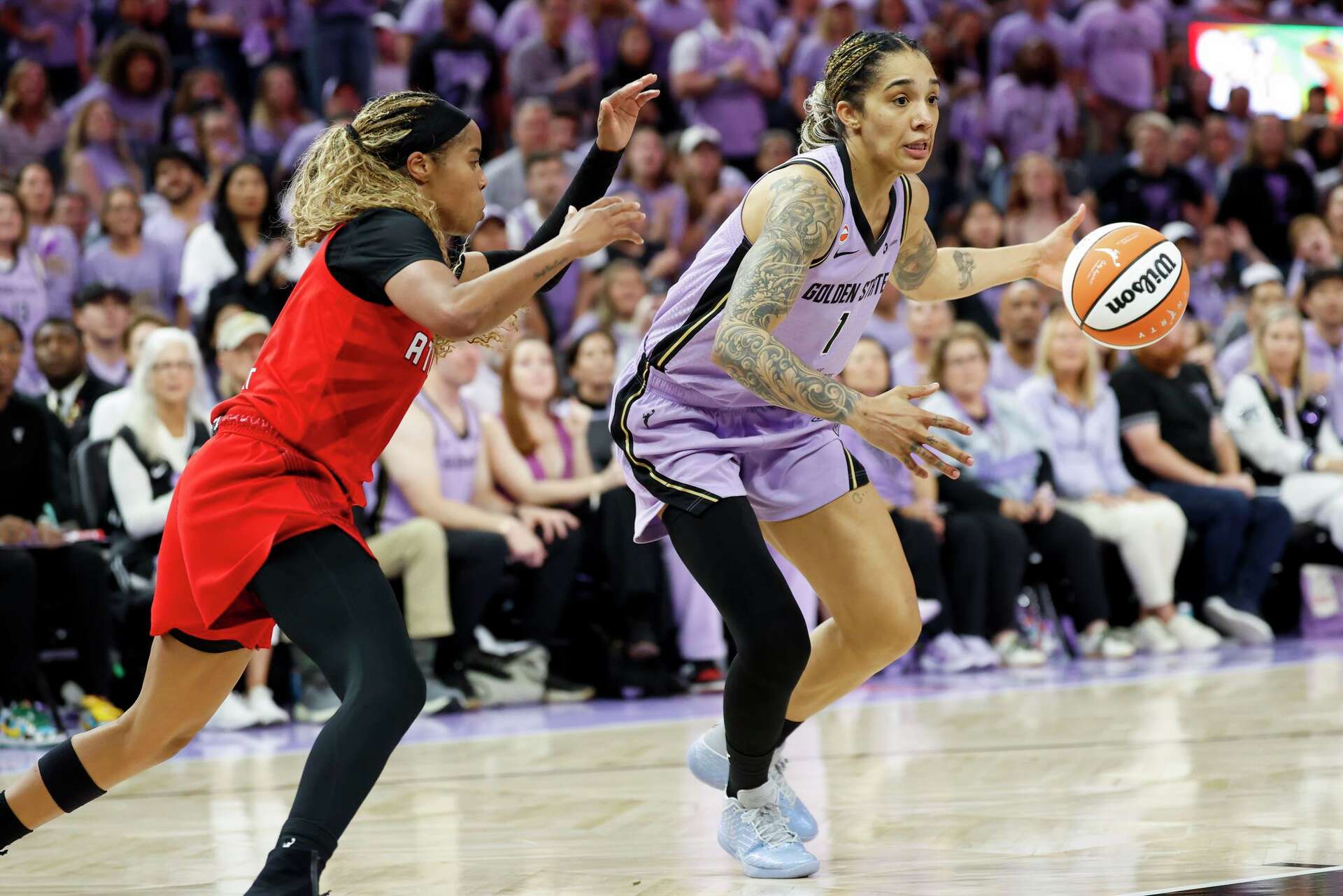 Golden State Valkyries forward Gabby Williams, right, moves the ball while defended by Atlanta Dream guard Jordin Canada during the second half of the WNBA Fina