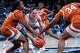 HARTFORD, CONNECTICUT - OCTOBER 19: Jovana Popovic #13 of the Connecticut Huskies is defended by Madison Booker #35 and Isi Etute #34 of the Texas Longhorns during the first half of the NCAA women's exhibition basketball game at PeoplesBank Arena.