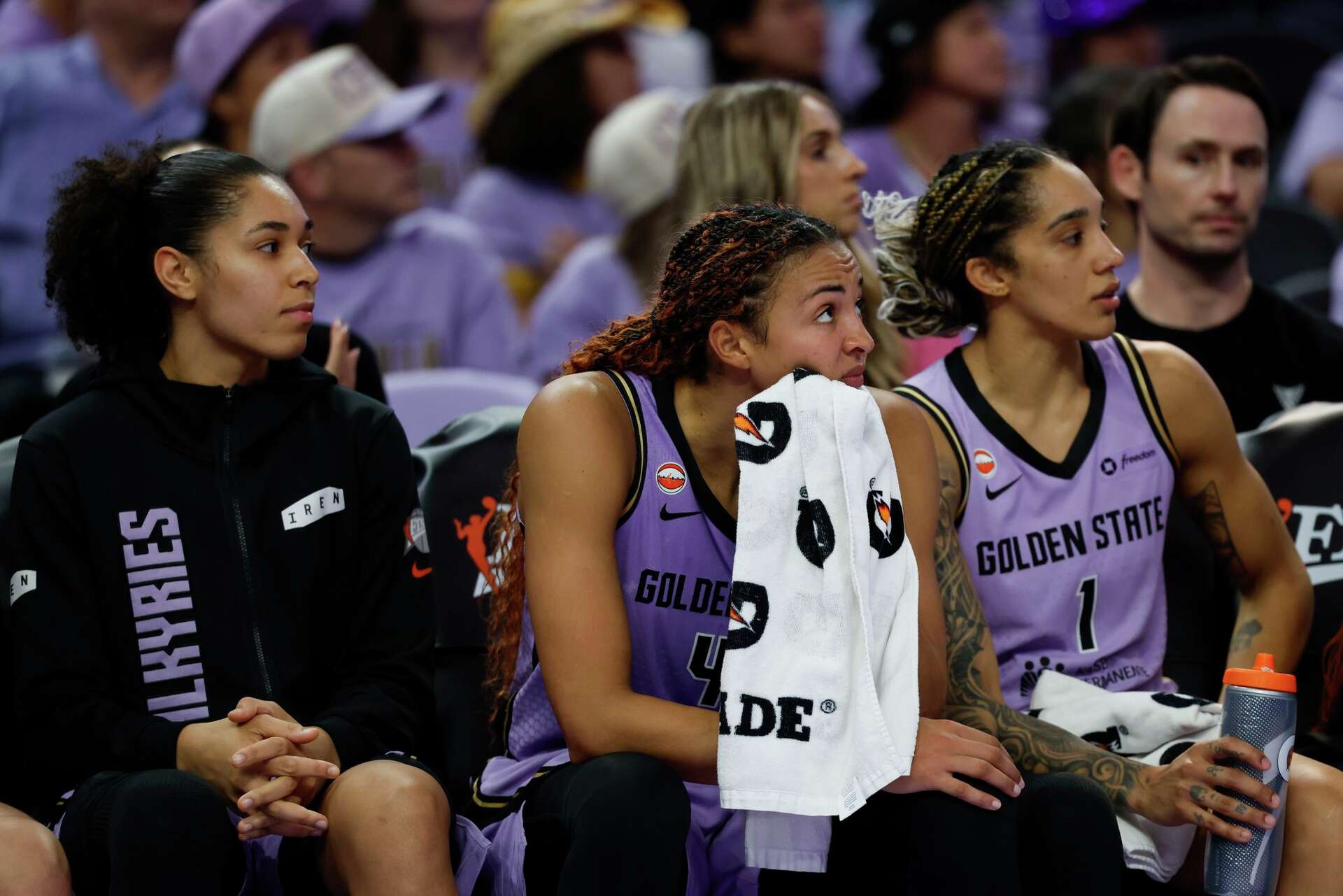 From left, Golden State Valkyries forward Janelle Salaün, center Kiah Stokes and forward Gabby Williams watch from on the bench Monday during the second half of