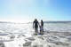 Catherine Breed stands with her sister and nephew Leo in the water at Coronado Beach.