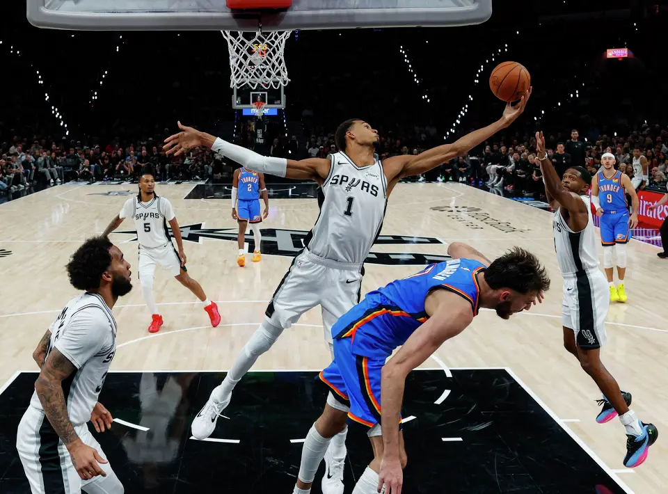 San Antonio Spurs forward Victor Wembanyama (1) reaches for a rebound during the second half of an NBA basketball game against the Oklahoma City Thunder on Tuesday, Oct. 20, 2026, in San Antonio. The Thunder won 116-104.