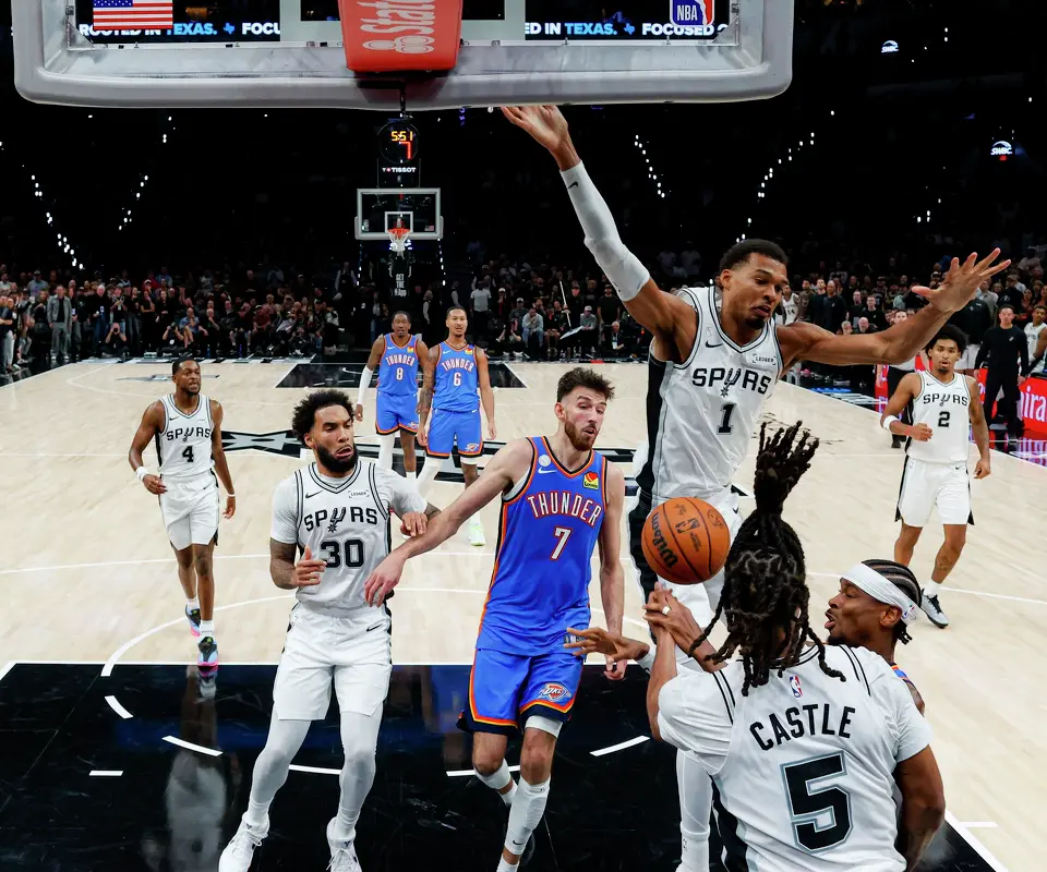 San Antonio Spurs guard Stephon Castle (5) fouls Oklahoma City Thunder guard Shai Gilgeous-Alexander (2) under the net during the second half of the NBA season opener at Frost Bank Center in San Antonio, Tuesday, Oct. 20, 2026. The Spurs fell to the Thunder 116-104.