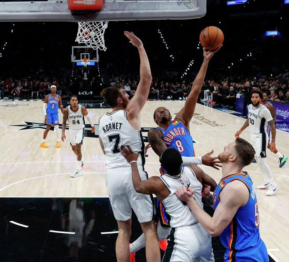 Oklahoma City Thunder guard Jalen Williams (8) goes up for a shot over San Antonio Spurs center Luke Kornet (7) during the second half of the NBA season opener at Frost Bank Center in San Antonio, Tuesday, Oct. 20, 2026. The Spurs fell to the Thunder 116-104.