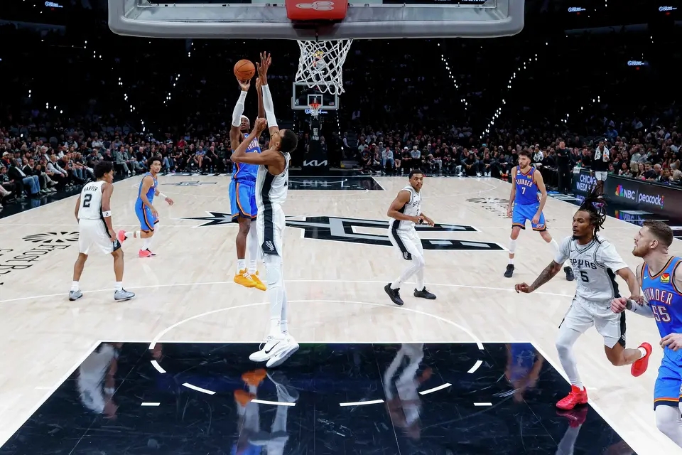 Oklahoma City Thunder guard Shai Gilgeous-Alexander (2) shoots over San Antonio Spurs forward Victor Wembanyama (1) during the second half of the NBA season opener at Frost Bank Center in San Antonio, Tuesday, Oct. 20, 2026. The Spurs fell to the Thunder 116-104.
