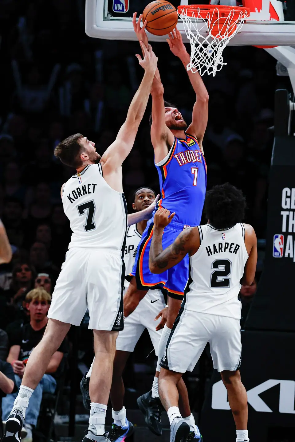 San Antonio Spurs center Luke Kornet (7) fouls Oklahoma City Thunder center Chet Holmgren (7) as Holmgren shoots during the second half of an NBA basketball game Tuesday, Oct. 20, 2026, in San Antonio. The Thunder won 116-104.