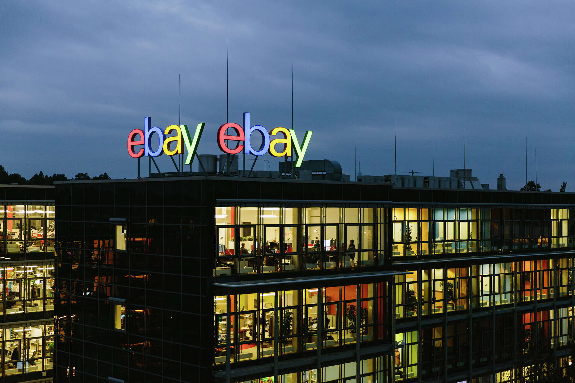 The eBay logo is seen at the Silicon Valley tech giant’s Berlin office. The company plans to cut about 1,000 jobs, or 9% of its workforce, in another restructur