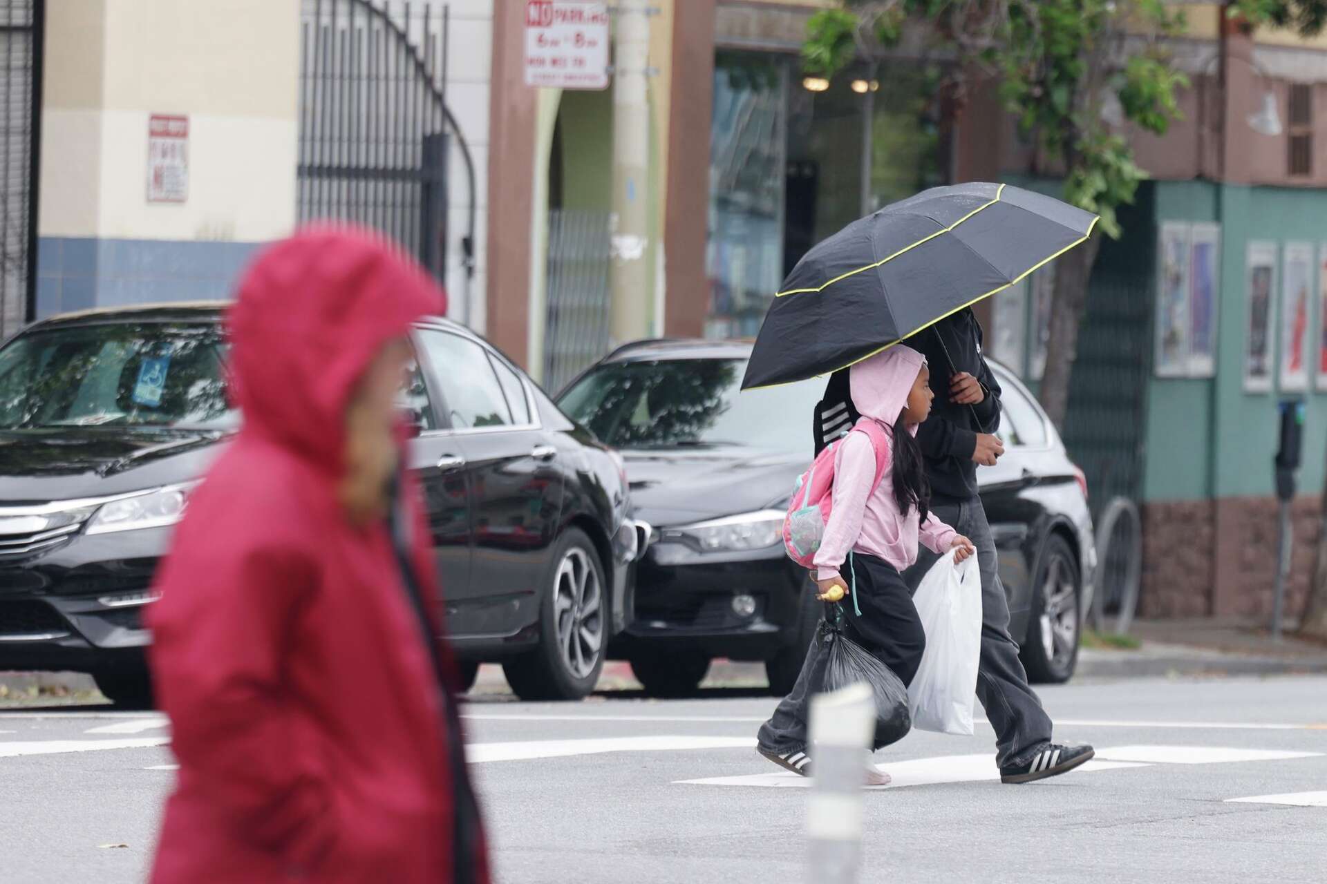 Rain is expected Wednesday night and into Thursday. Here, pedestrians cross Mission Street in San Francisco during a light shower in April.