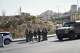Israeli soldiers gather at the scene of a shooting attack carried out by Palestinian gunmen at a junction near Hebron in the occupied West Bank on Friday, Oct. 23, 2026.
