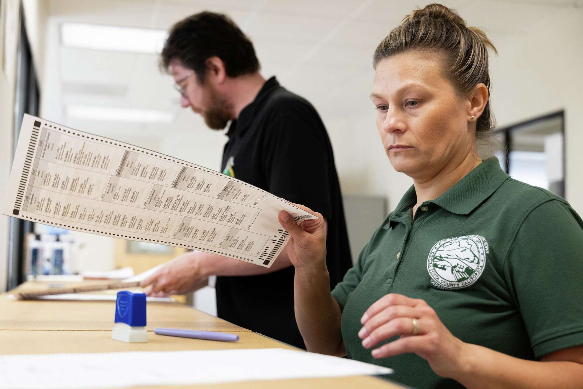 Election services specialist Alicia Little reviews test ballots at Contra Costa’s election offices in Martinez on May 8, 2026. The DOJ sent a letter to Contra C