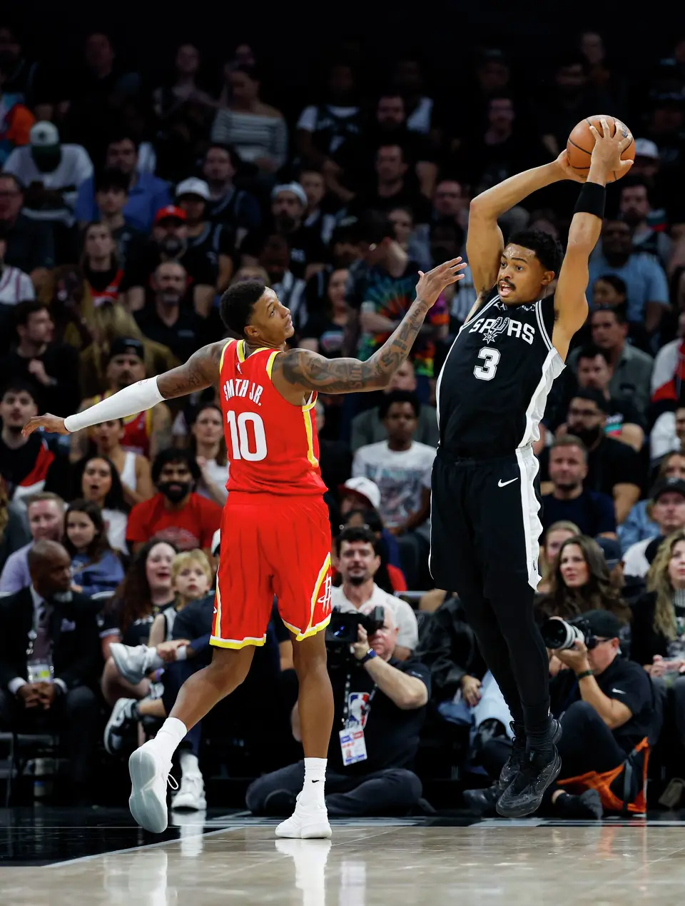 San Antonio Spurs forward Keldon Johnson (3) pulls down a rebound over Houston Rockets forward Jabari Smith Jr. (10) during the first quarter at Moody Center in Austin, Friday, Oct. 23, 2026.