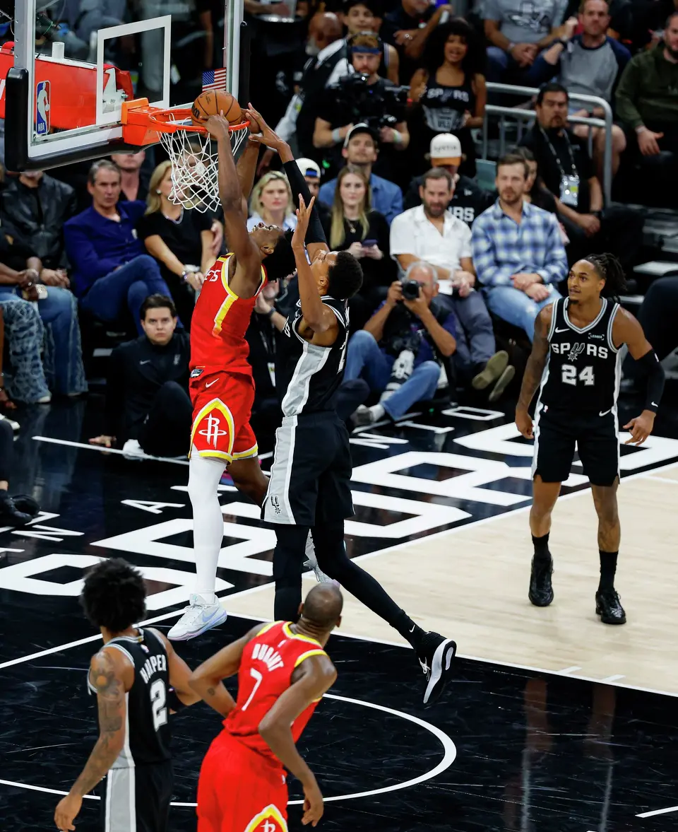 Houston Rockets guard Amen Thompson (1) dunks while being fouled by San Antonio Spurs forward Victor Wembanyama (1) during the third quarter at the Moody Center in Austin, Texas, Friday, Oct. 23, 2026. The Rockets won 114-110.