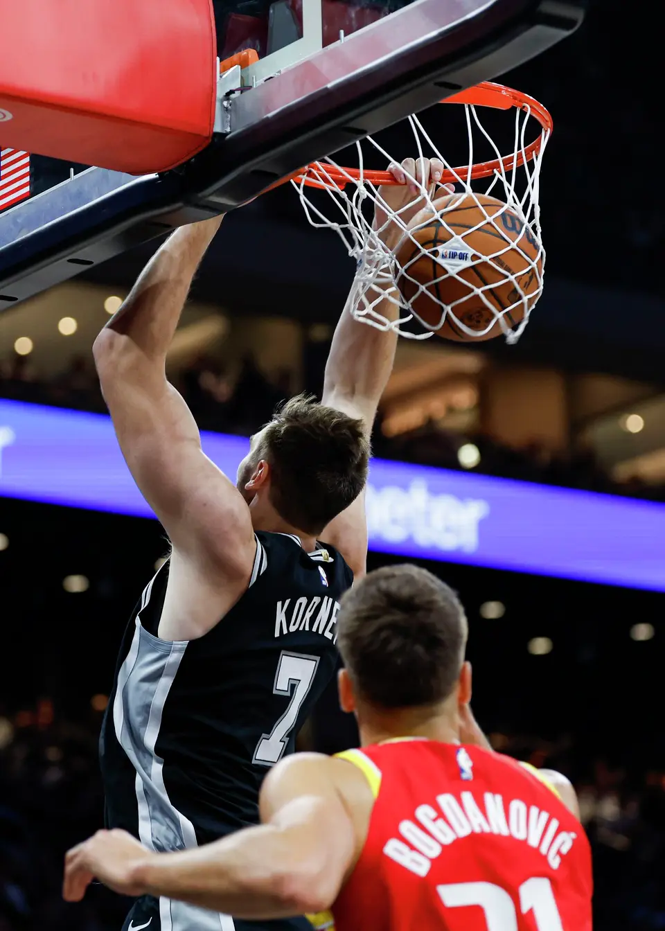 San Antonio Spurs center Luke Kornet (7) dunks backward against the Houston Rockets during the fourth quarter at the Moody Center in Austin, Texas, Friday, Oct. 23, 2026. The Rockets won 114-110.