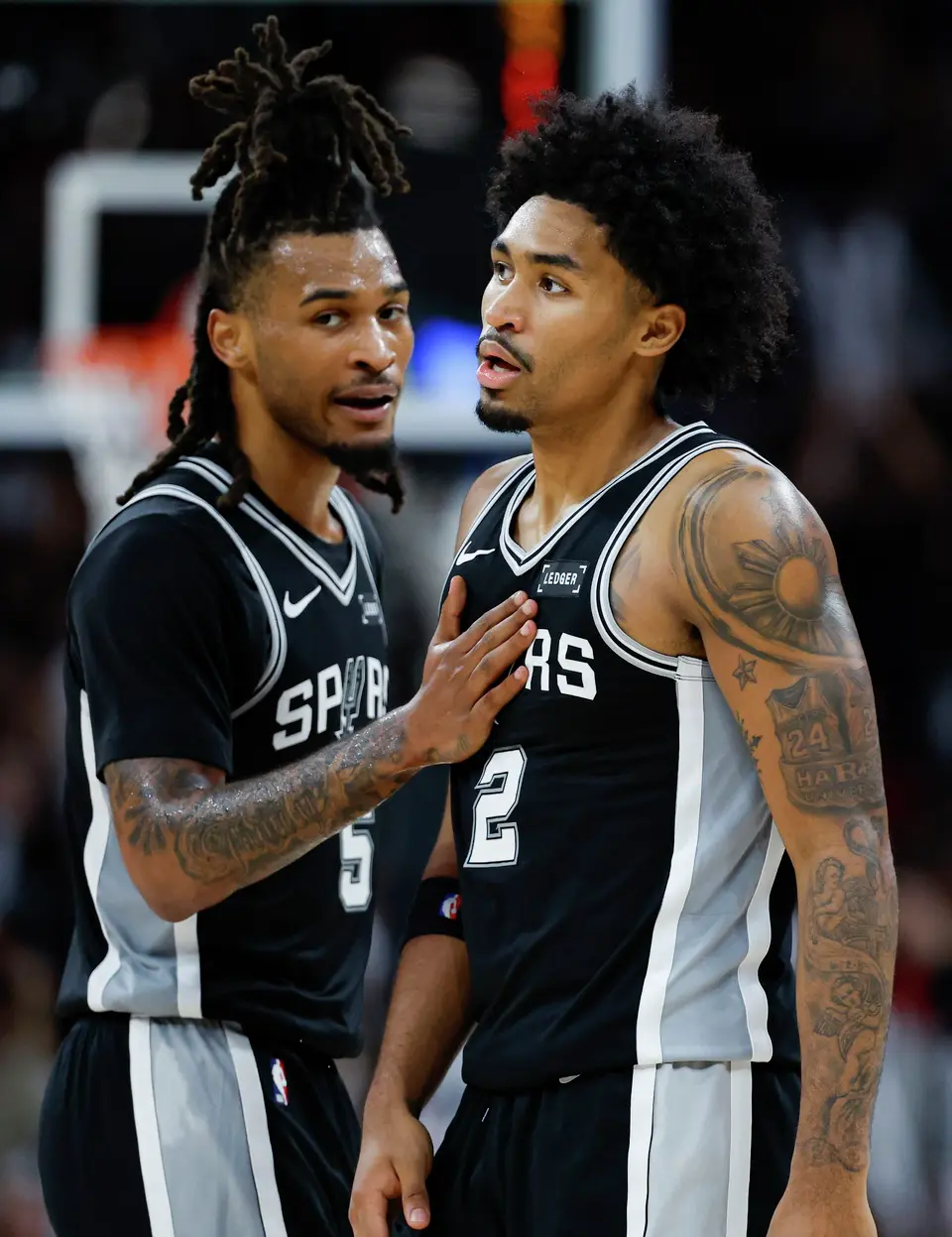 San Antonio Spurs guard Stephon Castle (5) talks to his teammate Dylan Harper (2) during the fourth quarter at Moody Center in Austin, Friday, Oct. 23, 2026. The Spurs fell 114-110 to the Rockets.