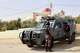 Jordanian police officers stand beside an armored vehicle outside St. George's Greek Orthodox Church a day after gunmen opened fire during a funeral in the village of Hamoud, in Jordan's Karak governorate, Saturday, Oct. 24, 2026.