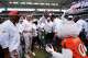 Members of Miami's 2001 National Championship football team celebrate with Miami mascot Sebastian the Ibis as they are honored at halftime of an NCAA college football game between Miami and Pittsburgh, Saturday, Oct. 24, 2026, in Miami Gardens, Fla.