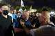 Gadi Eisenkot, leader of the Yashar ("Straight") party, center, is greeted by supporters at an anti-government rally ahead of Israel's general election, Saturday, Oct. 24, 2026, in Tel Aviv, Israel.