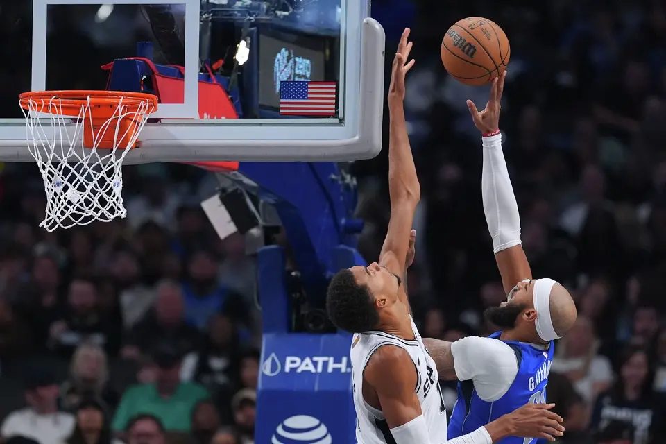 Dallas Mavericks forward Daniel Gafford, right goes up for a basket against San Antonio Spurs forward Victor Wembanyama during the second half of an NBA basketball game Saturday, Oct. 24, 2026, in Dallas. (AP Photo/Julio Cortez)