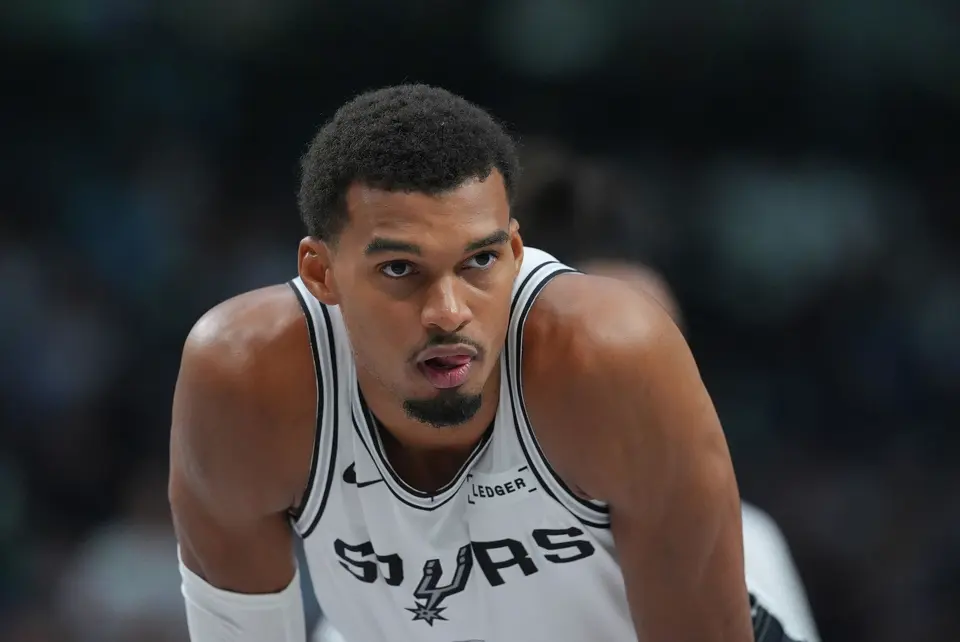 San Antonio Spurs forward Victor Wembanyama looks on during the second half of an NBA basketball game against the Dallas Mavericks, Saturday, Oct. 24, 2026, in Dallas. (AP Photo/Julio Cortez)