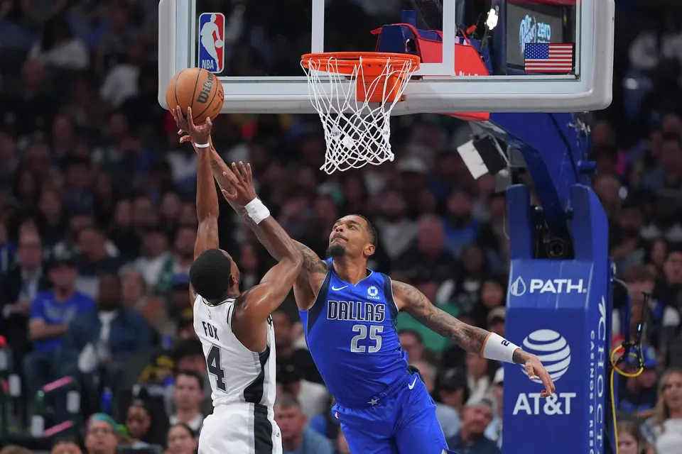 Dallas Mavericks forward P.J. Washington (25) blocks a shot by San Antonio Spurs guard De'aaron Fox (4) during the second half of an NBA basketball game Saturday, Oct. 24, 2026, in Dallas. (AP Photo/Julio Cortez)