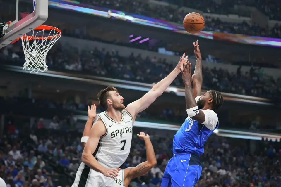 Dallas Mavericks forward Naji Marshall (3) shoots against San Antonio Spurs center Luke Kornet (7) during the first half of an NBA basketball game Saturday, Oct. 24, 2026, in Dallas. (AP Photo/Julio Cortez)