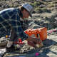 Assistant state paleontologist Don DeBlieux carefully brushes a fossil.