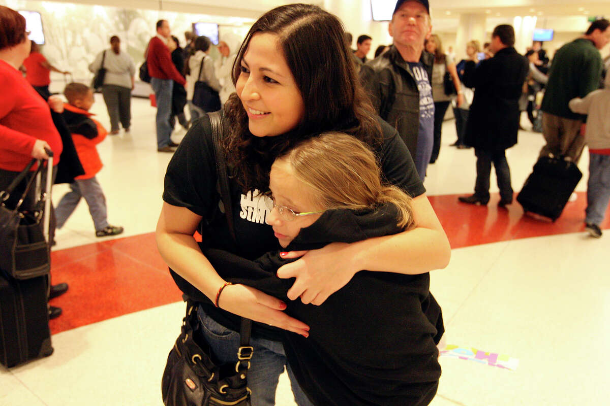 St. Mary’s University junior psychology major Priscilla Ortega hugs her sister, Sylvia Aguila-Ortega, on Sunday at the San Antonio International Airport. Priscilla and other students in a study-abroad program were stranded in London an extra week due to a blizzard.