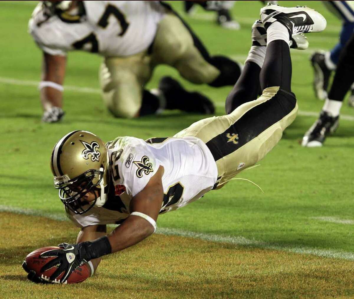 MIAMI GARDENS, FL - FEBRUARY 07: Pierre Thomas #23 of the New Orleans Saints leaps into the end zone to score a touchdown against of the Indianapolis Colts in the third quarter during Super Bowl XLIV on February 7, 2010 at Sun Life Stadium in Miami Gardens, Florida. (Photo by Elsa/Getty Images) *** Local Caption *** Pierre Thomas