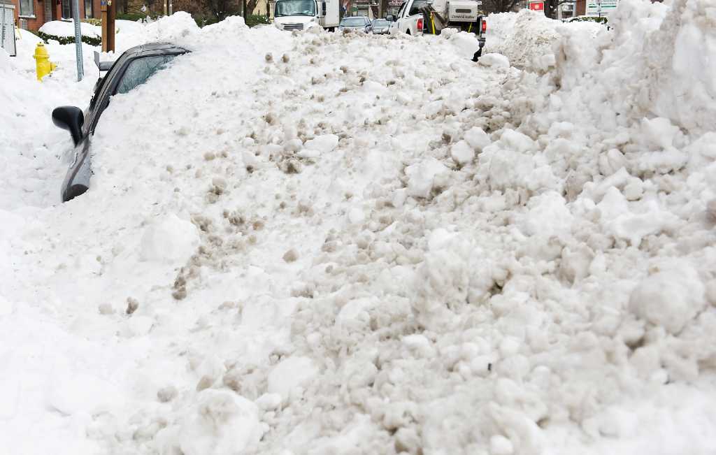 Parked cars are obstacles for city plows