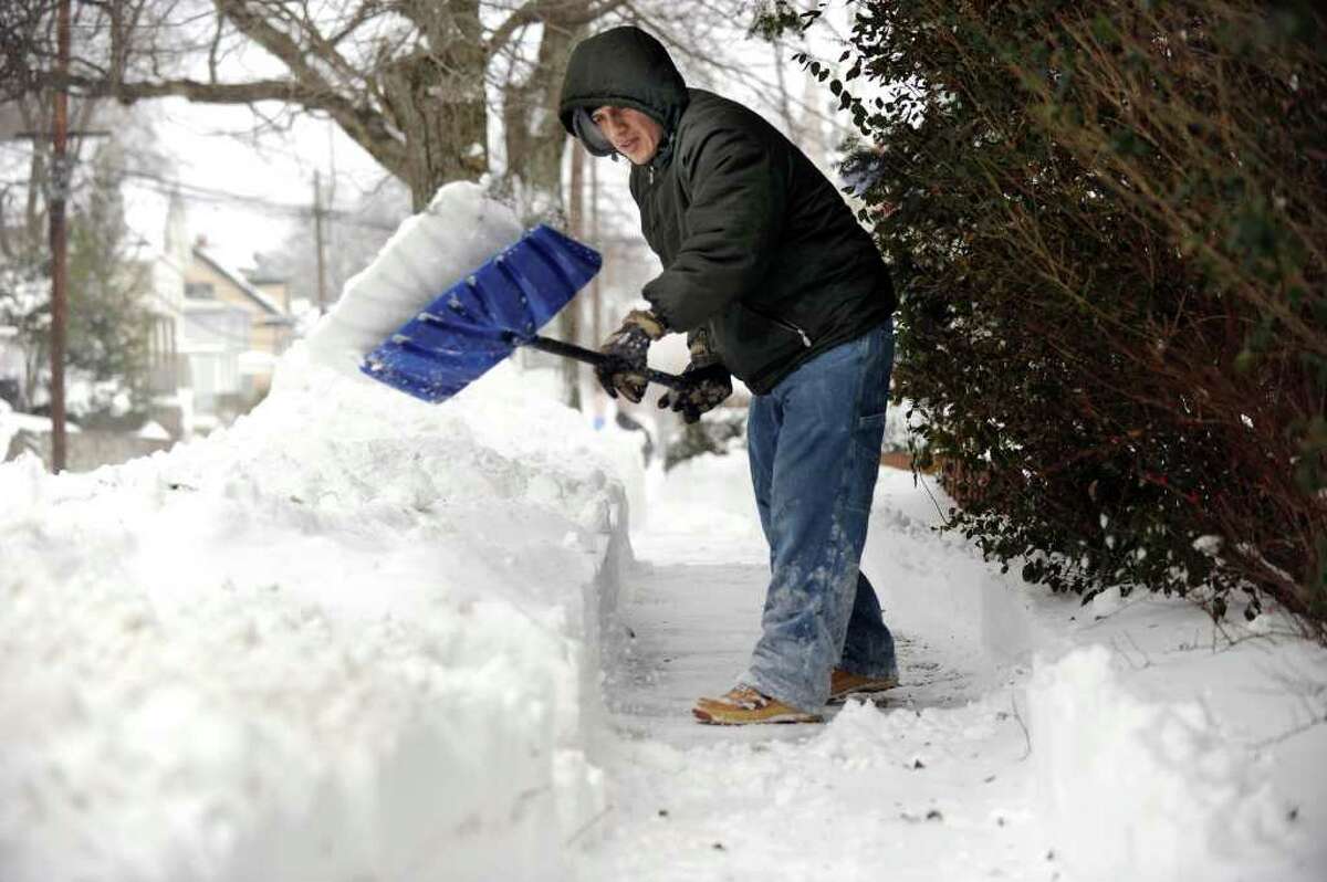 George Ordonez clears the walk in front of his Foster Street home in Danbury Monday, Dec. 27, 2010, after the over-night snow storm.