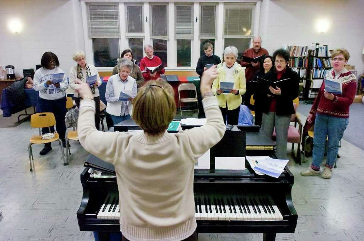 Pat Grimm, the director of music, conducts a rehearsal for the First United Methodist Church choir in Stamford, Conn. on Tuesday December 14, 2010.