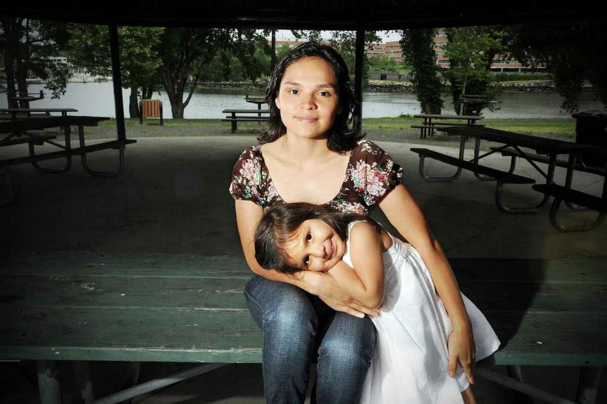 Celia Gonzalez, 25, photographed with her daughter Giselle Favian, 4, in Kosciuszko Park Tuesday June 22, 2010. Gonzalez moved to Stamford from El Salvador 6 years ago, she recently earned her high school diploma and is headed to college. "America, for me, is like a rainbow. It's everything. Whatever you want to be you can be. The country offers you so many things. For me it is the country where dreamers come to make their dreams come true. If you work and go to school you will succeed."