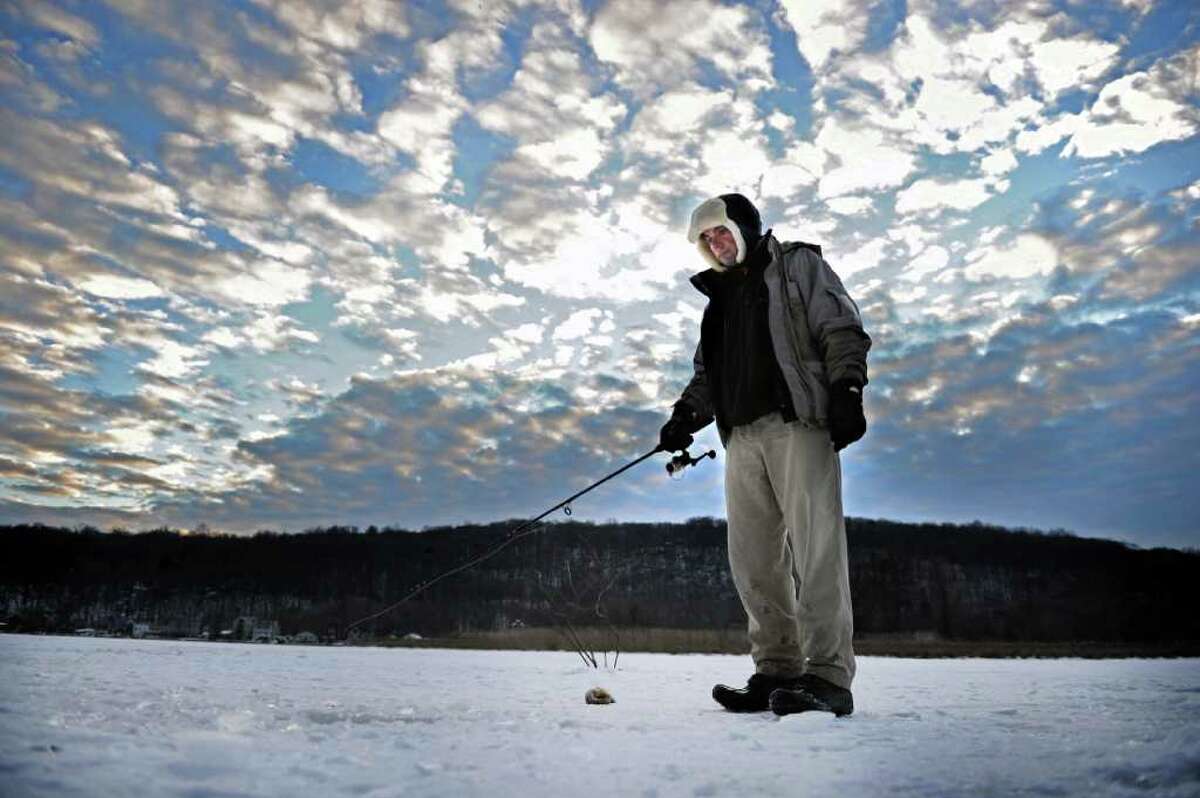 Ioan Stan, of East Haven, does some ice fishing Wednesday on the Housatonic River in Derby.