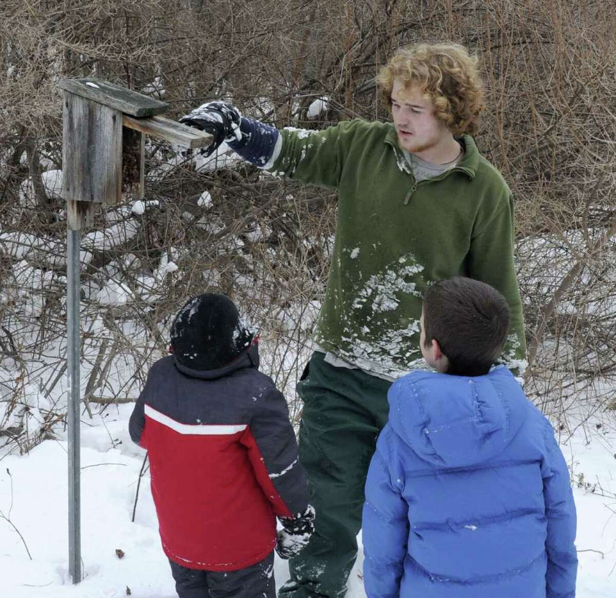Camp counselor Calder Gladstone, 19, shows Nathan Tietjen, 5, left, and Emmit Adjmi, 8, the inside of a bluebird house during the Pratt Nature Center winter camp in New Milford on Tuesday, Dec. 28, 2010.