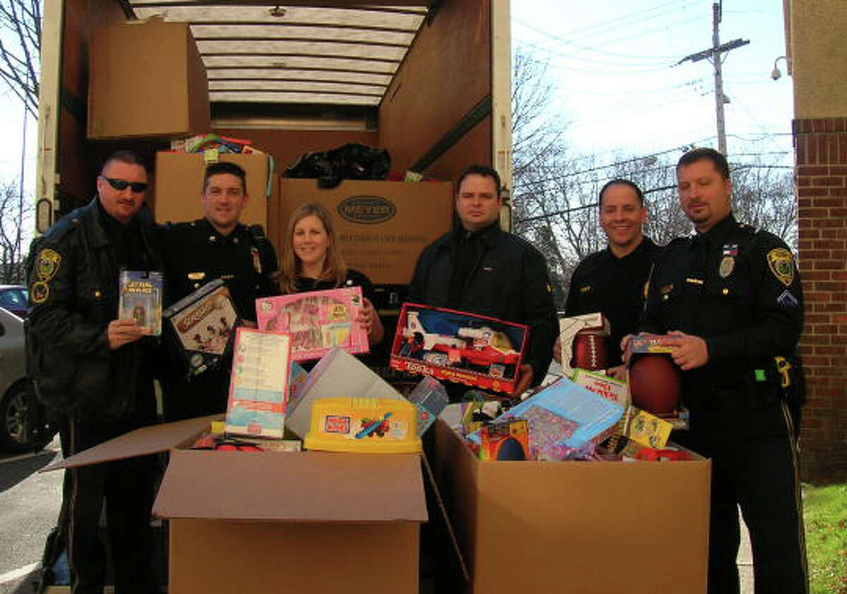 Officers from the Fairfield Police Department deliver toys collected during a holiday drive to Bridgeport Hospital. Over 1,000 toys were collected to help stock a toy closet at the hospital's P.T. Barnum Pediatric Center.