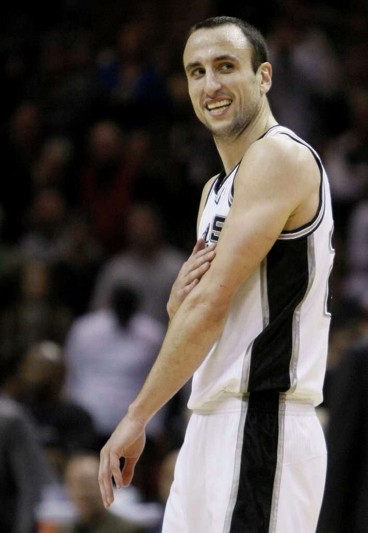 San Antonio Spurs' Manu Ginobili, of Argentina, smiles during the second half of an NBA basketball game against the Denver Nuggets, Wednesday, Dec. 22, 2010, in San Antonio. San Antonio won 109-103.