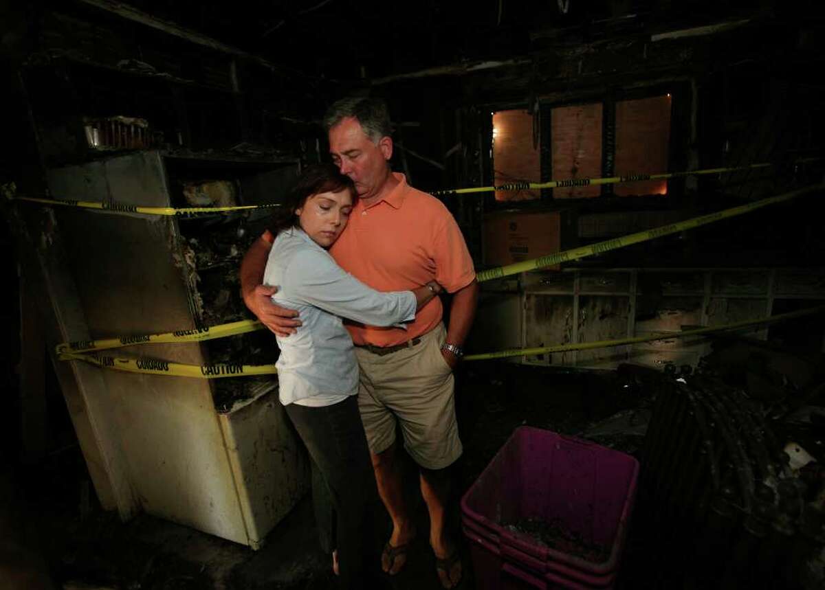 Anna and Eric Pelletier share a hug in the kitchen of their home at 46 Senior Place in Fairfield. The house was destroyed in a fire on Friday in which their two dogs perished.