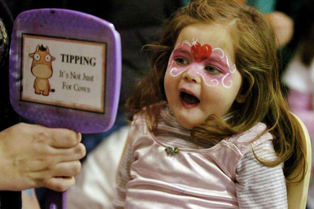 Sadie Katzner, 2, of Westport, reacts as she sees her face in the mirror, during First Night activities at the YMCA in downtown Westport, Conn. on Friday December 31, 2010.