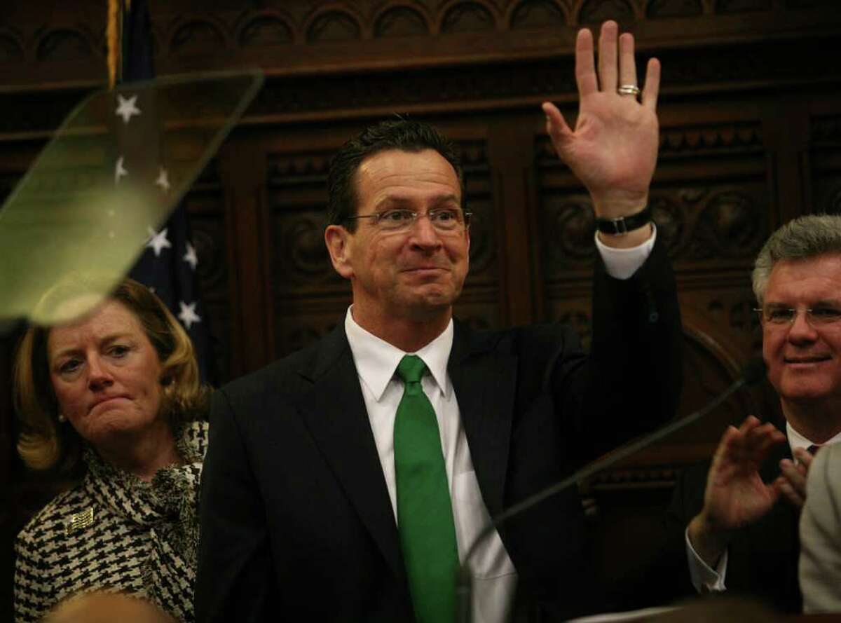 New Connecticut Governor Dannel Malloy waves as he prepares to address a joint session of the Connecticut General Assembly after his inauguration in Hartford on Wednesday, January 5, 2011.