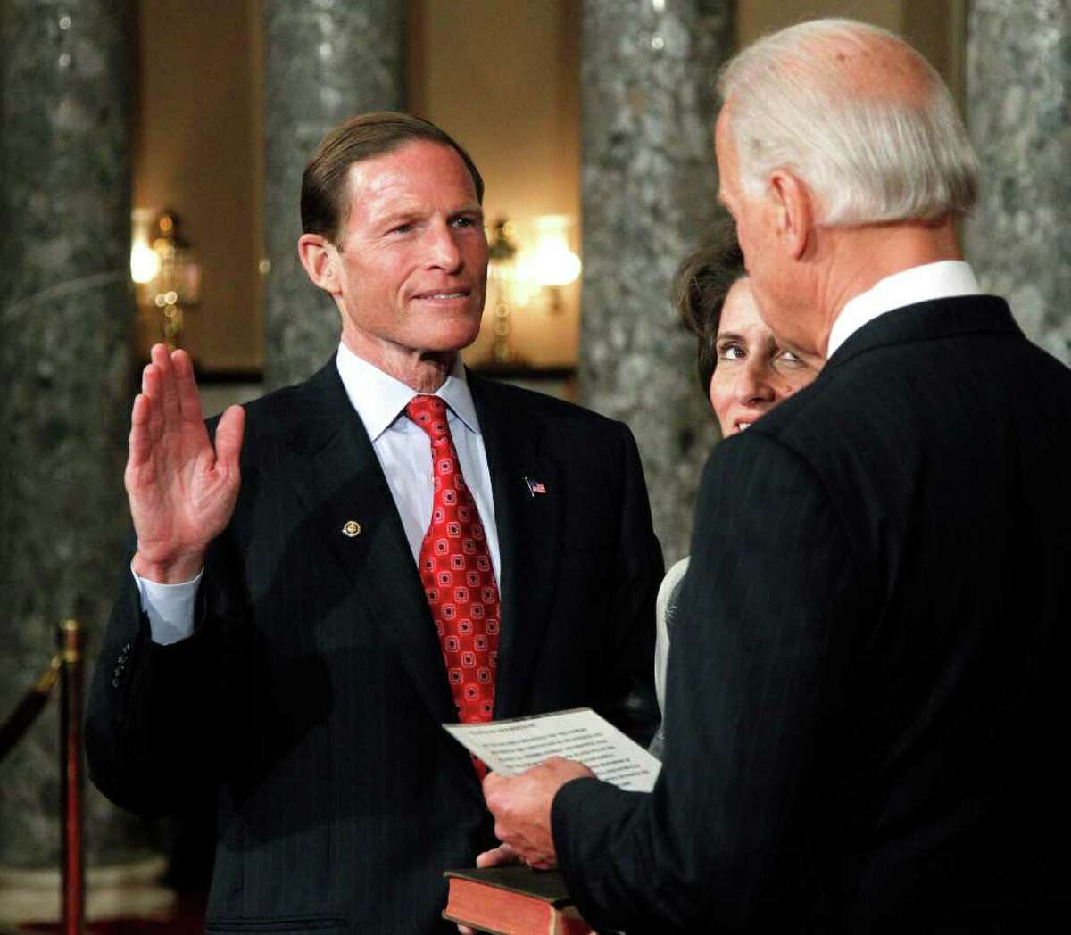 Vice President Joe Biden administers a ceremonial Senate oath during a mock swearing-in ceremony to Sen. Richard Blumenthal, D-Conn., left, accompanied by his wife Cynthia, Wednesday, Jan. 5, 2011, in the Old Senate Chamber on Capitol Hill in Washington. (AP Photo/Manuel Balce Ceneta)