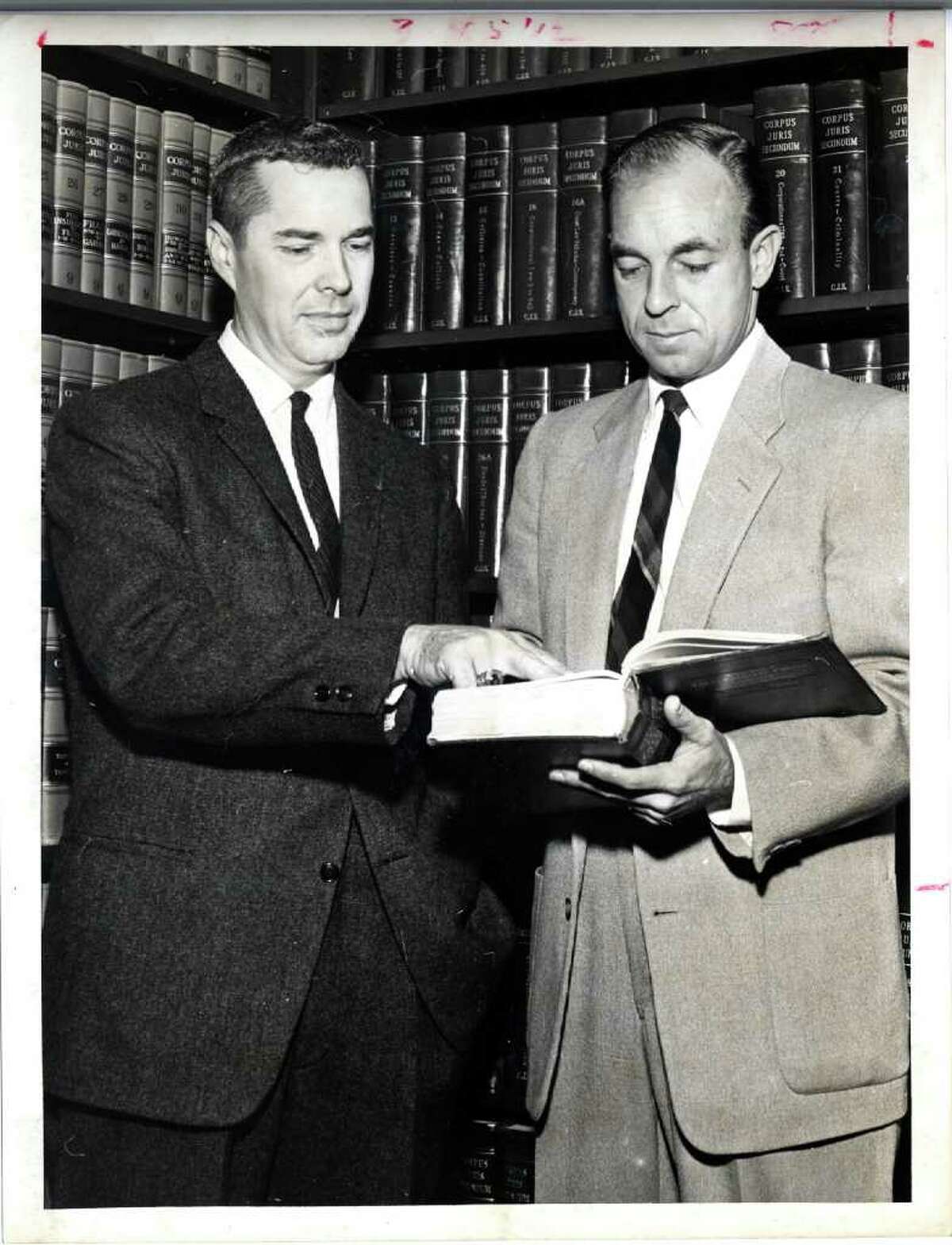 Frank Briscoe, left, and Wallace C. "Pete" Moore look at law book in 1960. Houston Chronicle file photo