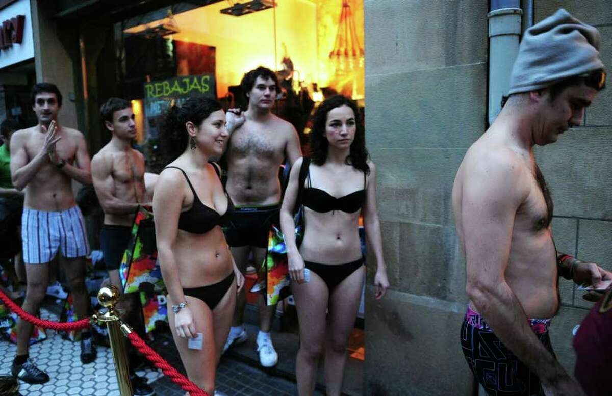 Customers wearing underwear queue outside a "Desigual shop on the first day of sales, on January 7, 2011 in the northern Spanish Basque city of San Sebastian. "Desigual" clothing company in San Sebastian, Barcelona and Marbella, asked customers to visit their stores wearing underwear in order to get free clothes during the first sale day in Spain. AFP PHOTO/ RAFA RIVAS (Photo credit should read RAFA RIVAS/AFP/Getty Images)