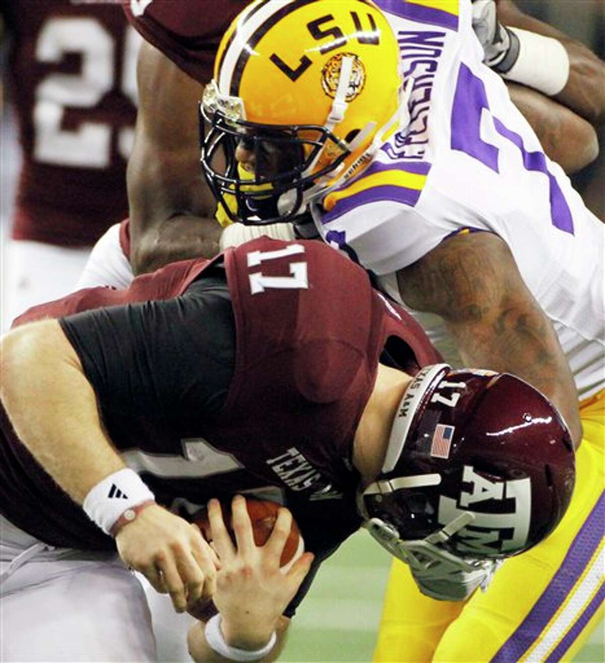 LSU's Patrick Peterson catches Texas A&M quarterback Ryan Tannehill by the face mask during the second half of Friday night's Cotton Bowl. The Aggies lost 41-24.