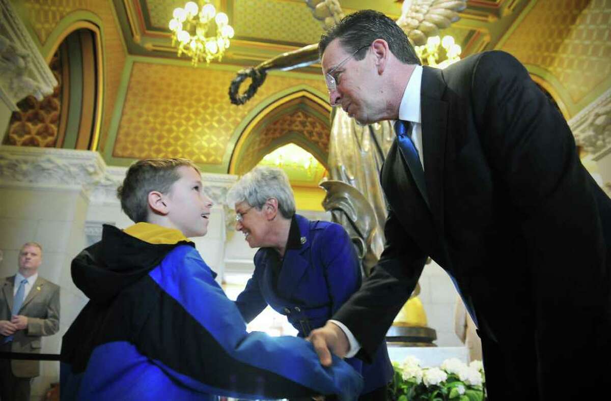 Liam Flynn, 9 of Wethersfield, shakes hands with Governor Dannel P. Malloy during a meet-and-greet with the Governor and Lieutenant Governor Nancy Wyman at the State Capitol in Hartford, Conn. on Saturday January 8, 2011.