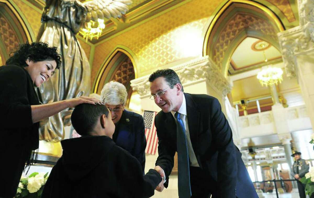 Governor Dannel P. Malloy shakes hands with Jalen Bowen, 6, as he and his mother Brenda Colon, of Windsor, meet the Governor and Lieutenant Governor Nancy Wyman during a meet-and-greet at the State Capitol in Hartford, Conn. on Saturday January 8, 2011.