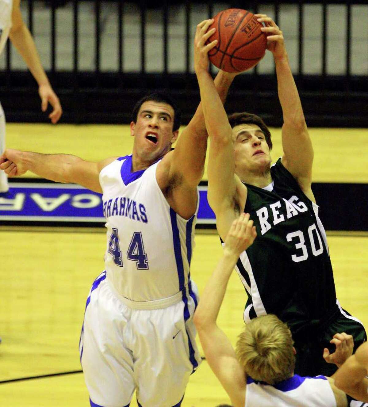 MacArthur's Jace Amaro and Reagan's Brad Coulter grab for a rebound during second half action on Monday, Jan. 10, 2011, at Littleton Gymnasium. Reagan won 61-57.