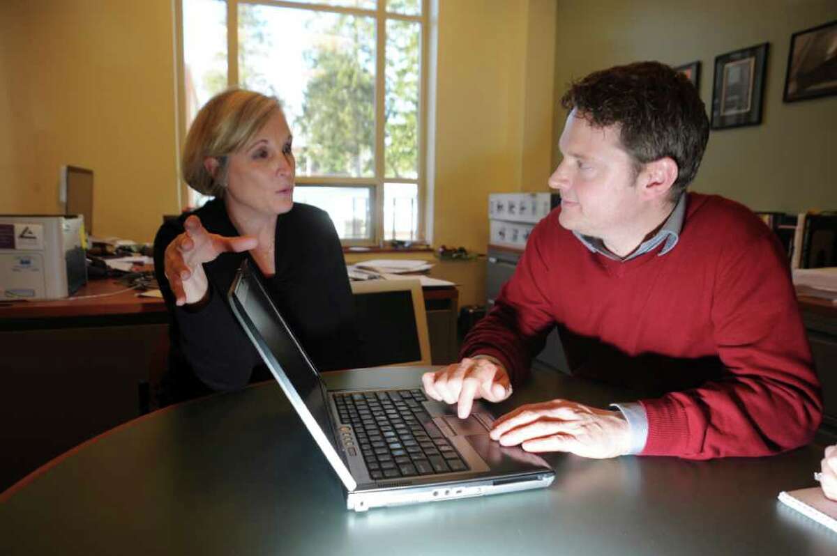 Convent of the Sacred Hearts fourth-grade teacher, Kerri Moore, left, speaks with Karl Haeseler, the school's director of educational technology, about the variety of computer programs that allow them to give online lessons on Tuesday, Jan. 11, 2011.
